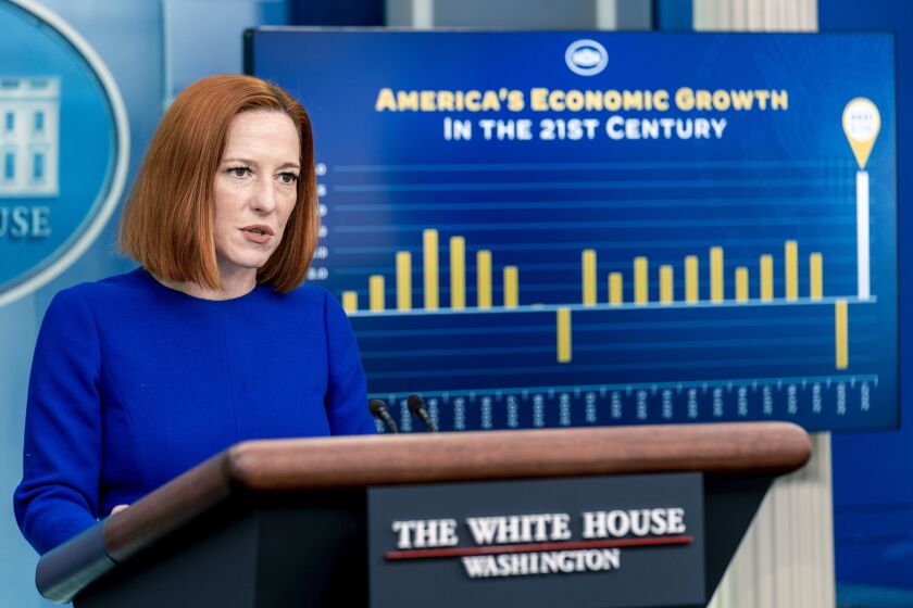 A monitor displays a graph showing American economic growth in the 21st century as White House press secretary Jen Psaki speaks at a press briefing at the White House in Washington, Thursday, Jan. 27, 2022. (AP Photo/Andrew Harnik)