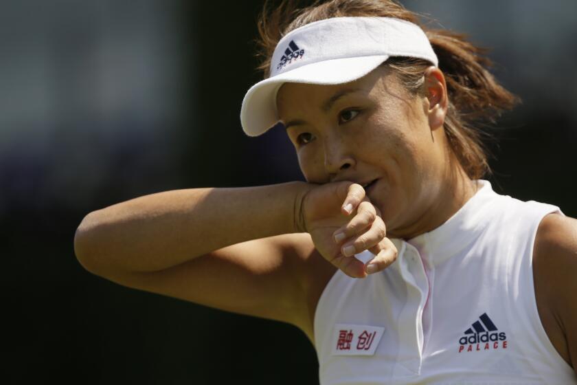 Peng Shuai of China wipes her face during the women's singles match against Samantha Stosur of Australia on the second day at the Wimbledon Tennis Championships in London, on July 3, 2018. China's Foreign Ministry is sticking to its line that it isn't aware of the controversy surrounding tennis professional Peng Shuai, who disappeared after accusing a former top official of sexually assaulting her. A ministry spokesperson said Friday that the matter was not a diplomatic question and that he was not aware of the situation. (AP Photo/Tim Ireland, File)
