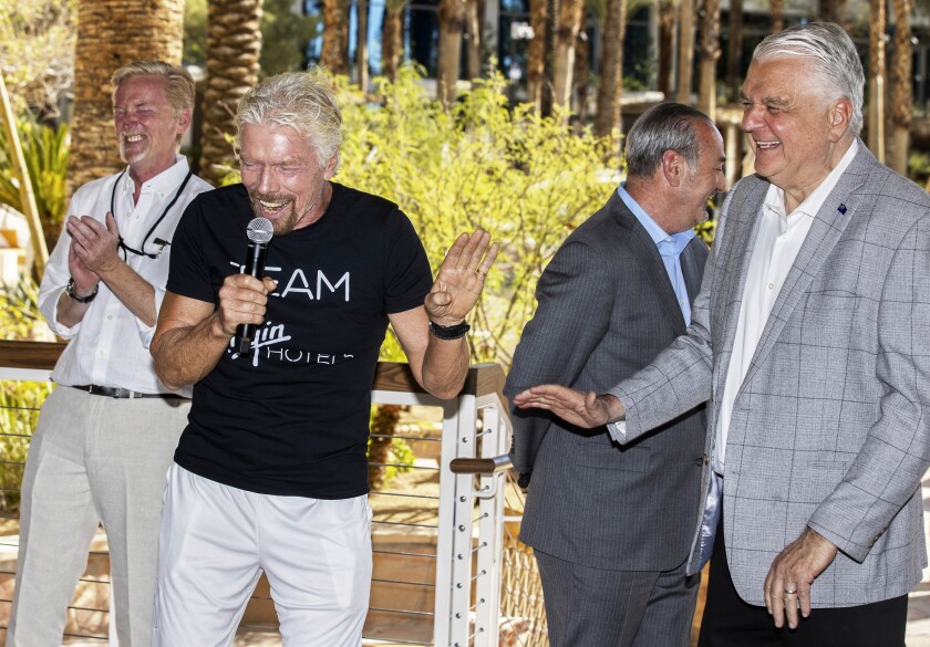 Sir Richard Branson, second from left, founder of Virgin Group, laughs with Nevada Gov. Steve Sisolak during the "Unstoppable Weekend" kickoff party at Virgin Hotels Las Vegas on Thursday, June 10, 2021. (Benjamin Hager/Las Vegas Review-Journal via AP)