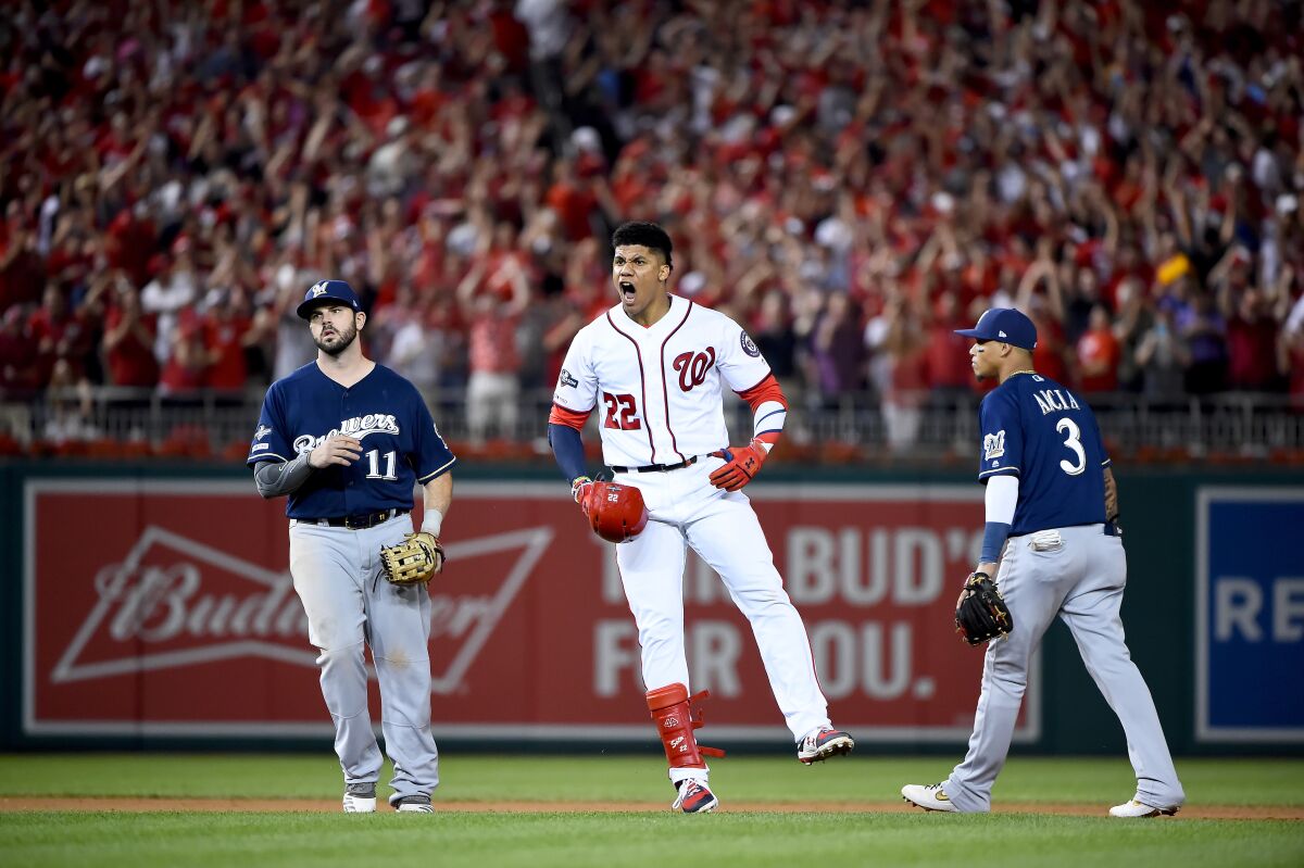 Washington Nationals' Juan Soto celebrates after hitting a single to right field to score three runs against the Milwaukee Brewers during the eighth inning in the National League Wild Card game at Nationals Park on Tuesday in Washington, D.C.