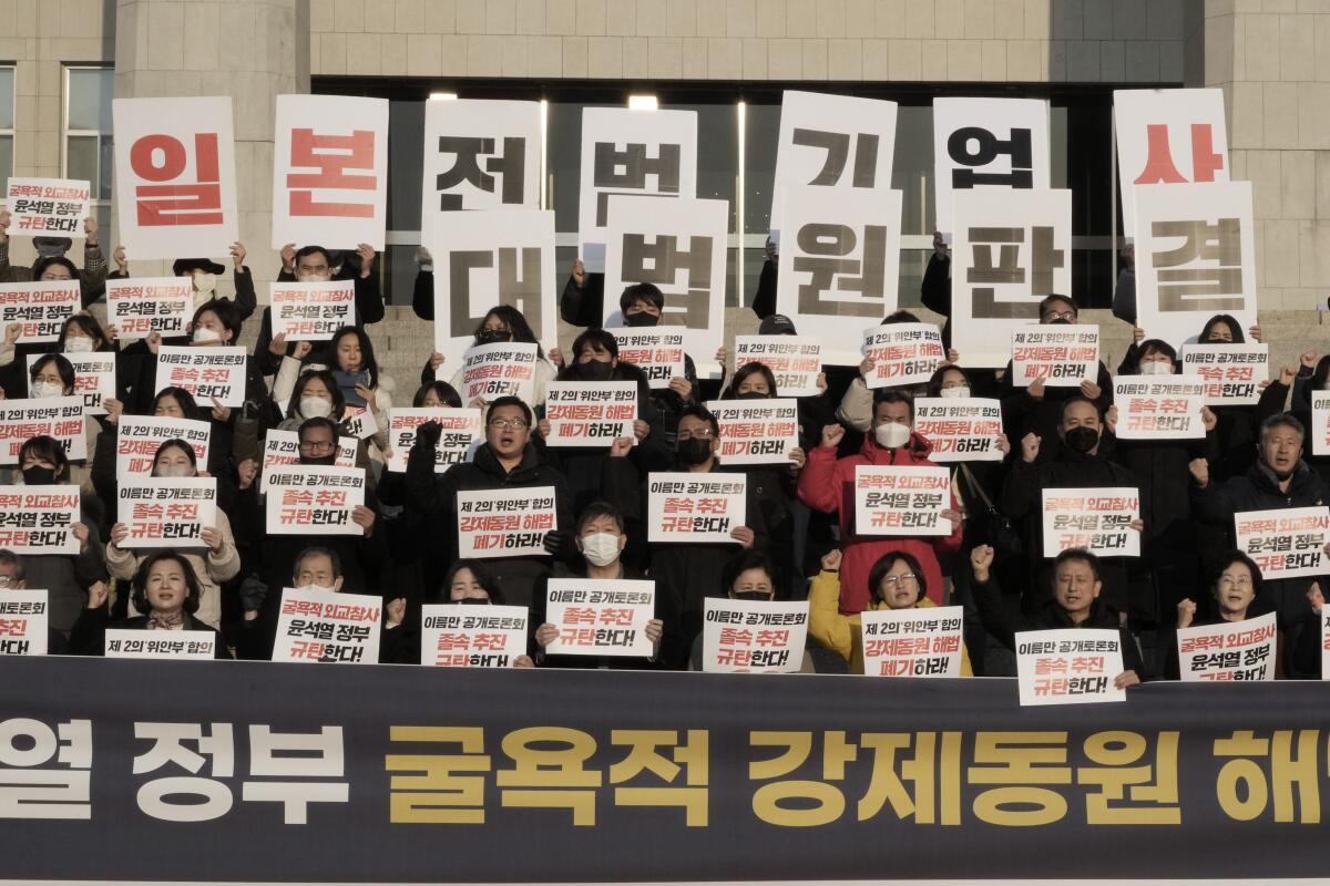 Lines of protesters holding signs. 