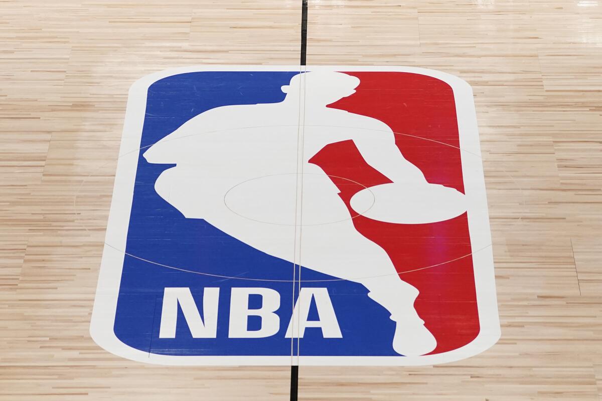 NBA logo on a hardwood court.