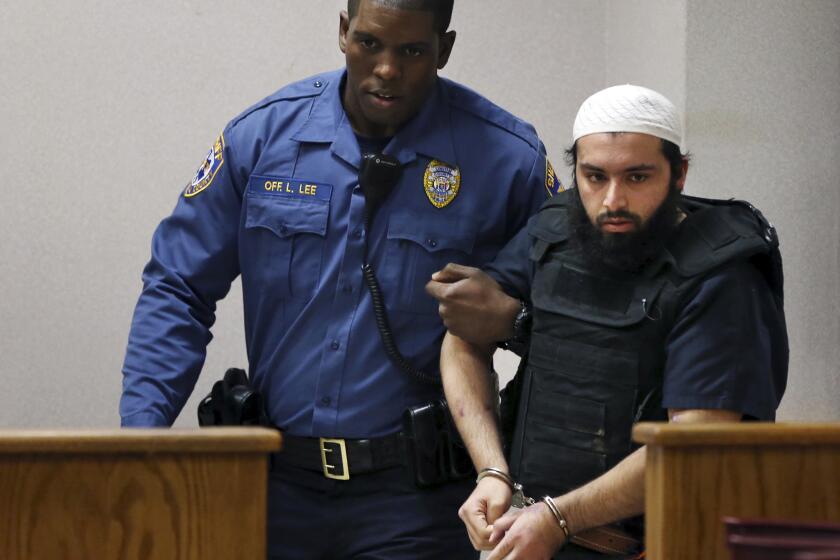 Ahmad Khan Rahimi, the man accused of setting off bombs in New Jersey and New York in September, is led into court Tuesday.