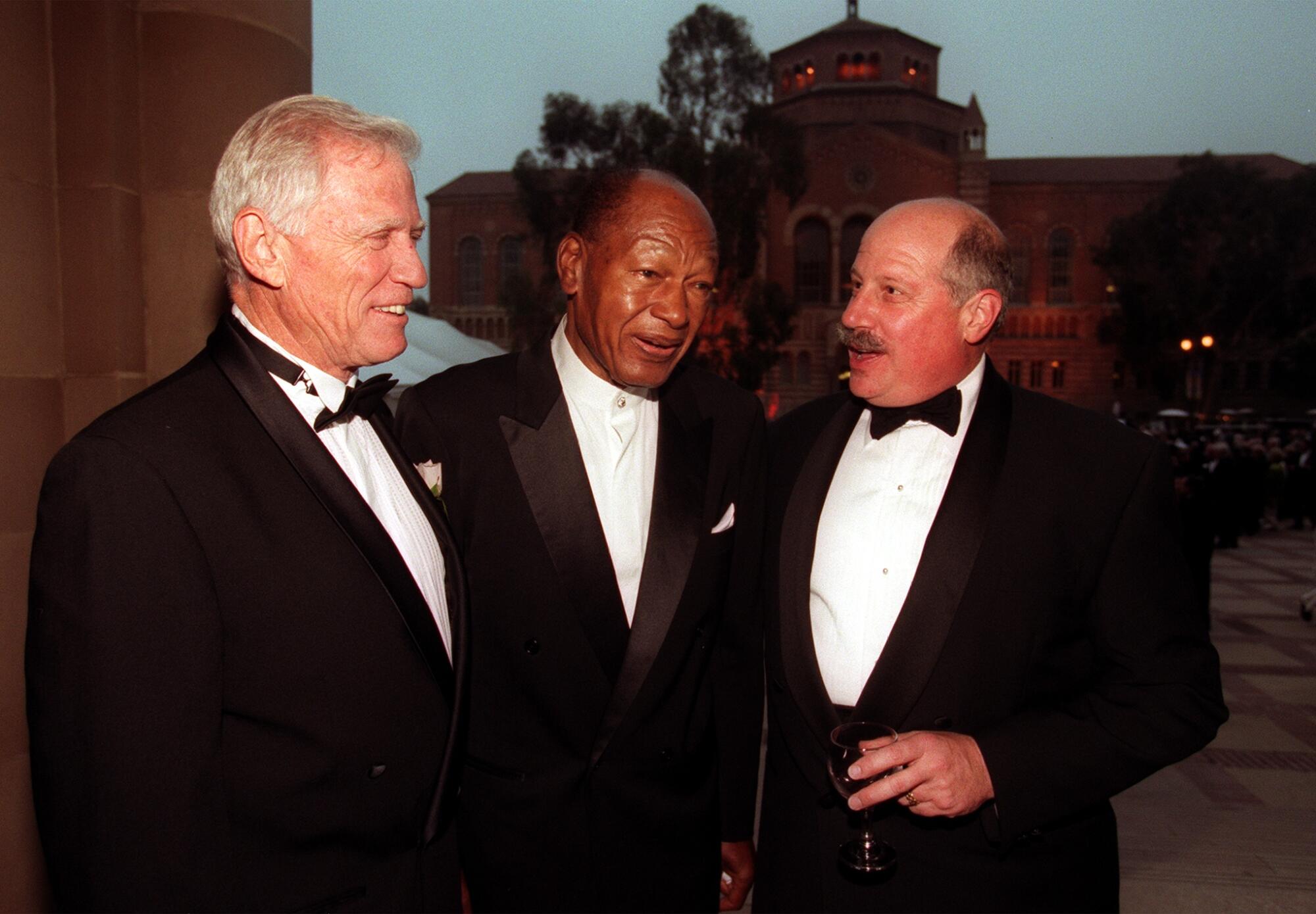 Retiring UCLA Chancellor Charles Young, left, shares a monent with former L.A. City Mayor Tom Bradley and Robert Michaels.