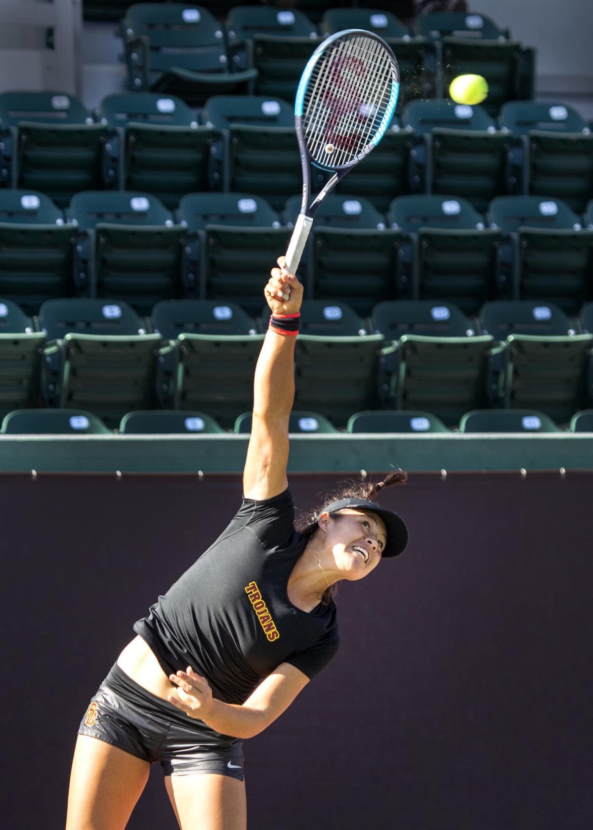 USC tennis player Angela Kulikov serves the ball during a doubles game at USC.