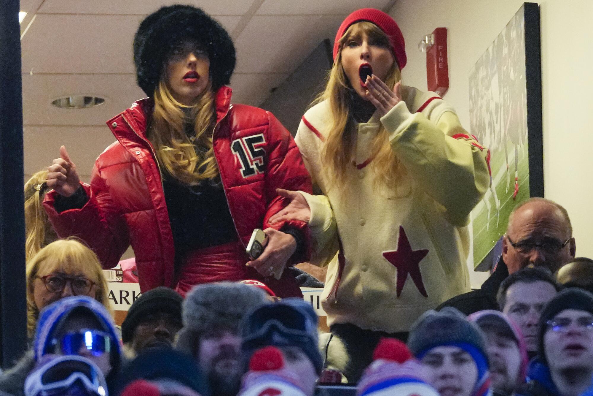 Taylor Swift, right, and Brittany Mahomes react during the NFL AFC division playoff football game against the Bills.