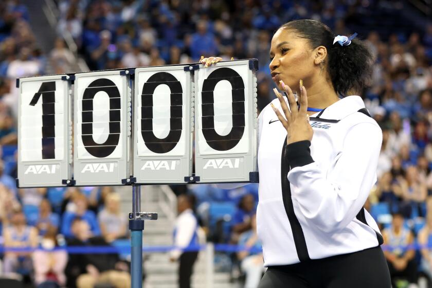 LOS ANGELES, CALIFORNIA - FEBRUARY 11: Jordan Chiles of the UCLA Bruins poses with a perfect 10.