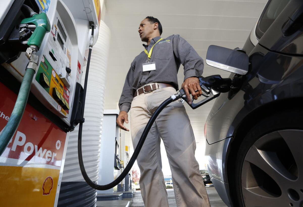 Eric Henry gases up his car in Sacramento last year. State lawmakers want to make sure gas prices stay low.