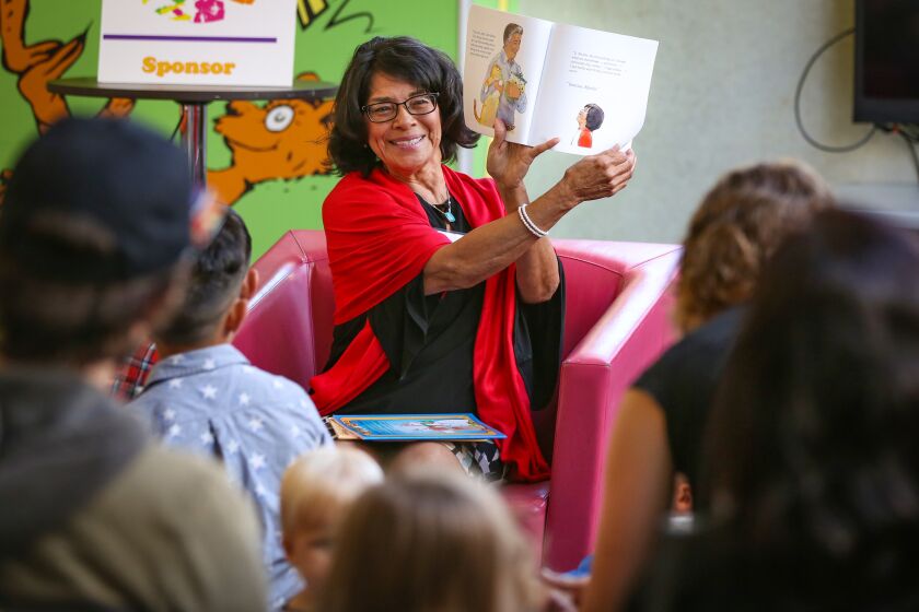 SAN DIEGO CA 4/13/2019: Children's book author Marta Arroyo, a retired school teacher from Oceanside, reads her book, Jorge and the Lost Cookie Jar, illustrated by Penny Weber, to children and adults during Writers Festival San Diego at the San Diego Central Library. Photo by Howard Lipin/ The San Diego Union-Tribune