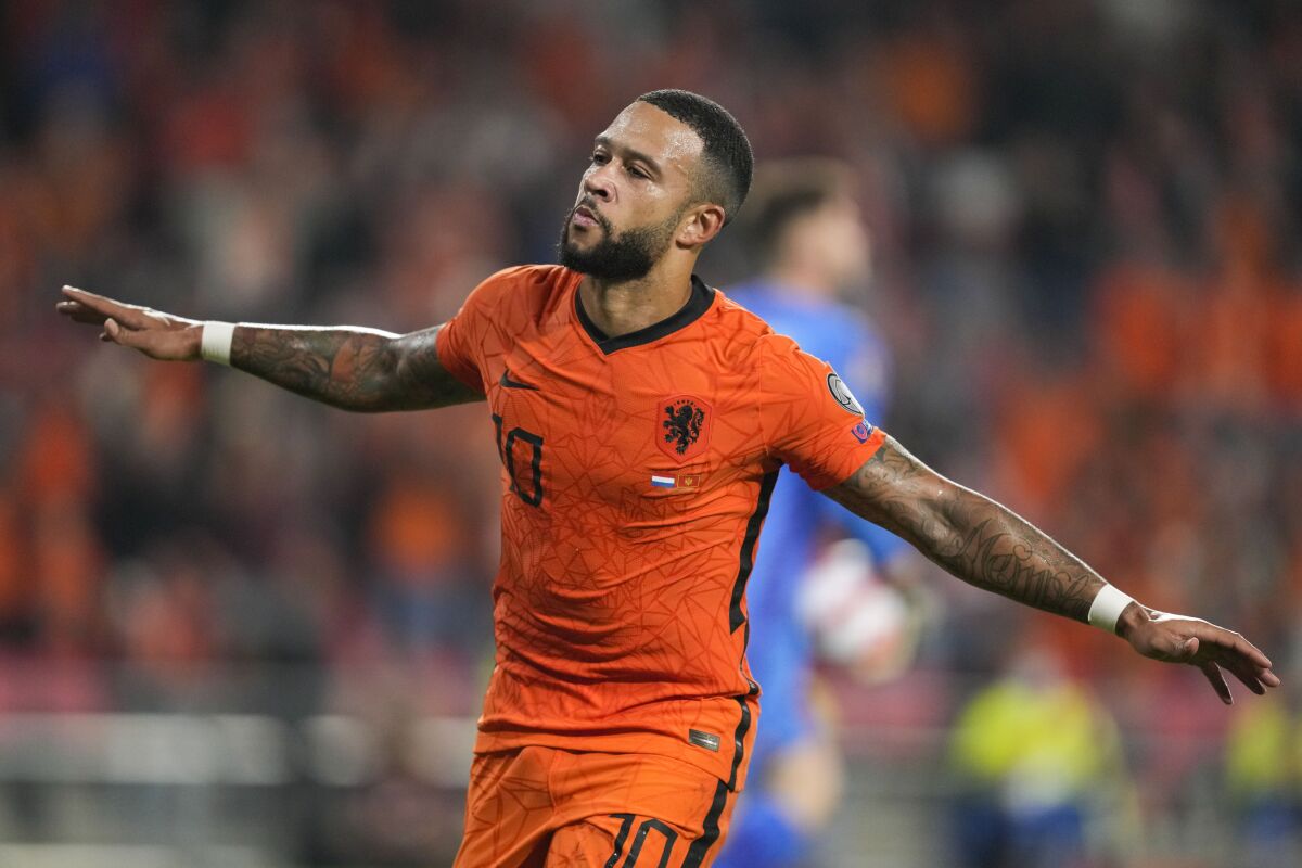 Memphis Depay of the Netherlands celebrates scoring his side's first goal during the World Cup 2022 group G qualifying soccer match between the Netherlands and Montenegro at the Philips stadium in Eindhoven, Netherlands, Saturday, Sept. 4, 2021. (AP Photo/Peter Dejong)