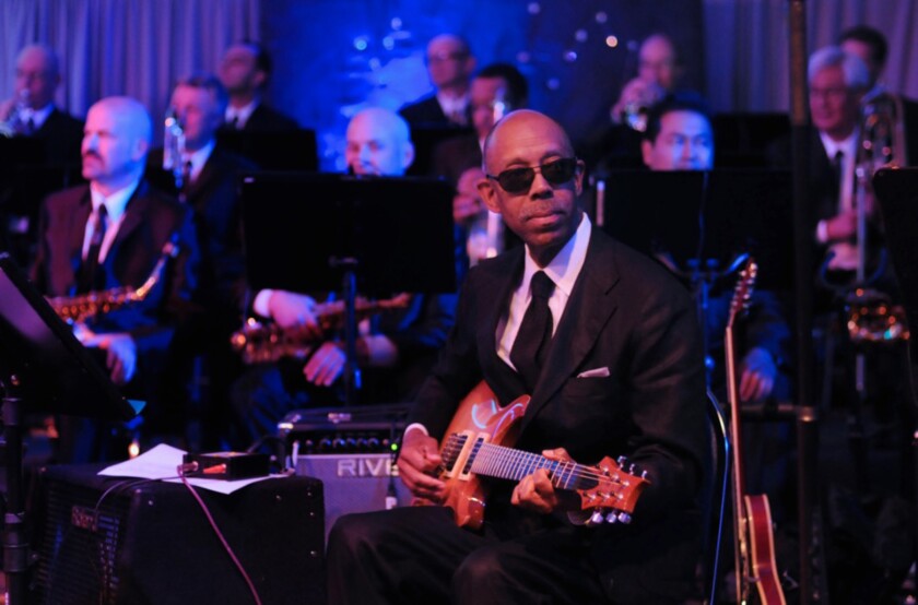 2015 photo shows UCI Chancellor Michael Drake playing the guitar with JT and California Dreamin.
