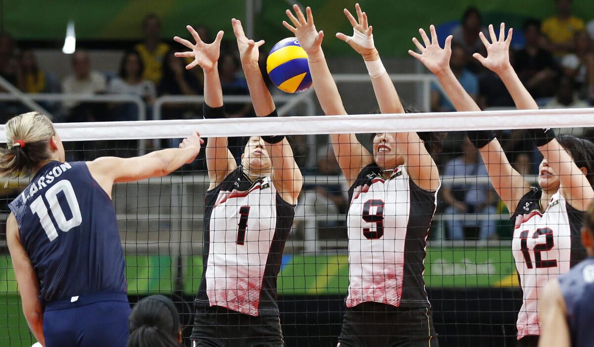 Jordan Larson-Burbach, left, of the U.S. in action against Nagaoka Miyu, second left, Shimamura Haruyo, second right, and Ishii Yuki of Japan during the women's volleyball quarterfinal match on Tuesday.