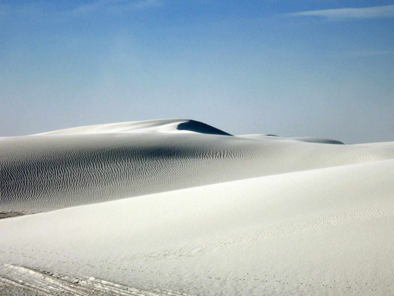 White Sands National Monument is the largest pure gypsum dune field in the world. The national monument offers visitors a drive through the fields, as well as an explanation of how all that sand got there.