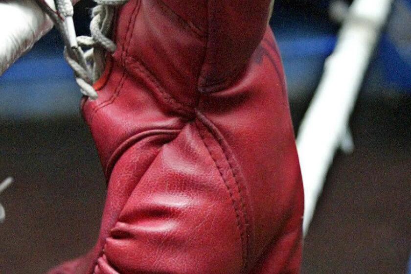 Boxing gloves are left on a training ring in a gym in Manila, Philippines.