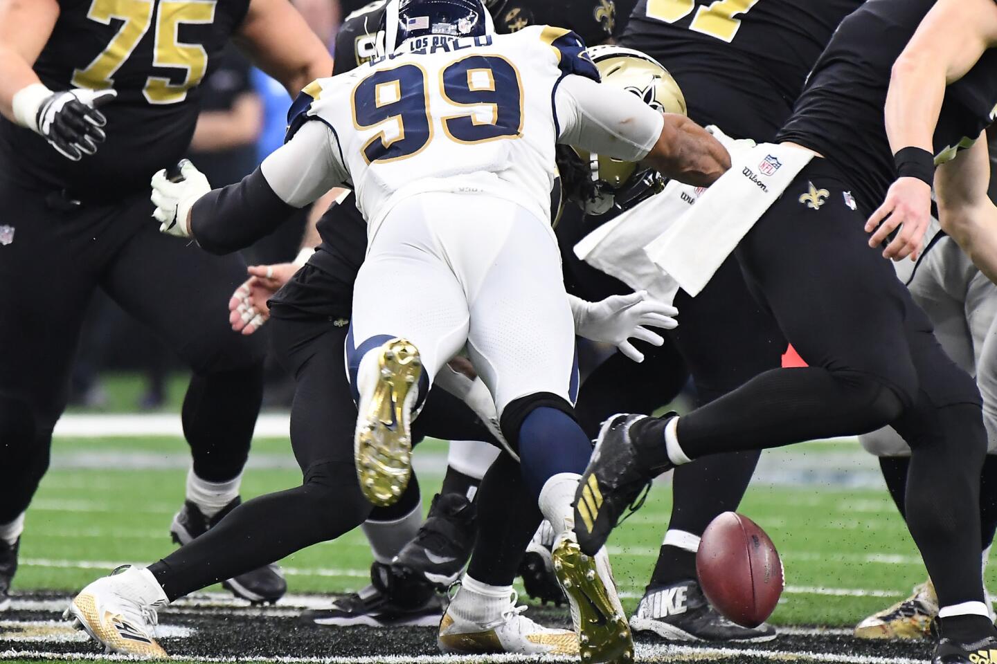 Rams defensive end Aaron Donald strips the ball of New Orleans Saints running back Alvin Kamara in the third quarter in the NFC Championship at the Superdome in New Orleans Sunday. Kamara recovered the ball.