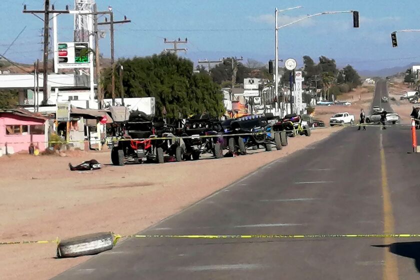 Members of the army and police secure the perimeter at the site of a long-gun attack on a group of amateur rally drivers in Ensenada, Mexico, on May 20, 2023. At least 10 people were killed and nine wounded on Saturday when gunmen attacked a group of amateur rally drivers in the northern Mexican town of Ensenada, near the US border, authorities said. (Photo by Joatam DE BASADE / AFP) (Photo by JOATAM DE BASADE/AFP via Getty Images)