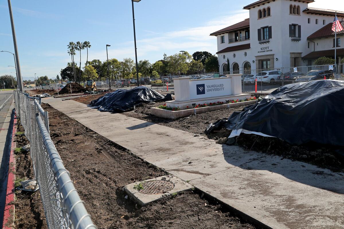 The sidewalk along Fair Drive is fenced off for construction work at Vanguard University in Costa Mesa. 