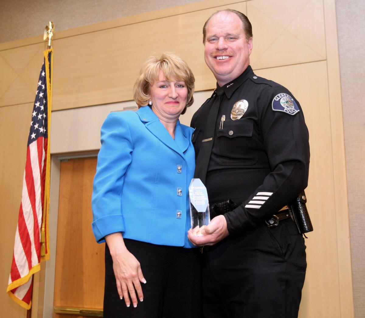 Boardwalk Properties' Elizabeth Manesserian received the Woman of the Year award from Glendale Police Department Deputy Chief Carl Povilaitis at this year's luncheon at the Hilton in Glendale on Thursday, March 31, 2016.