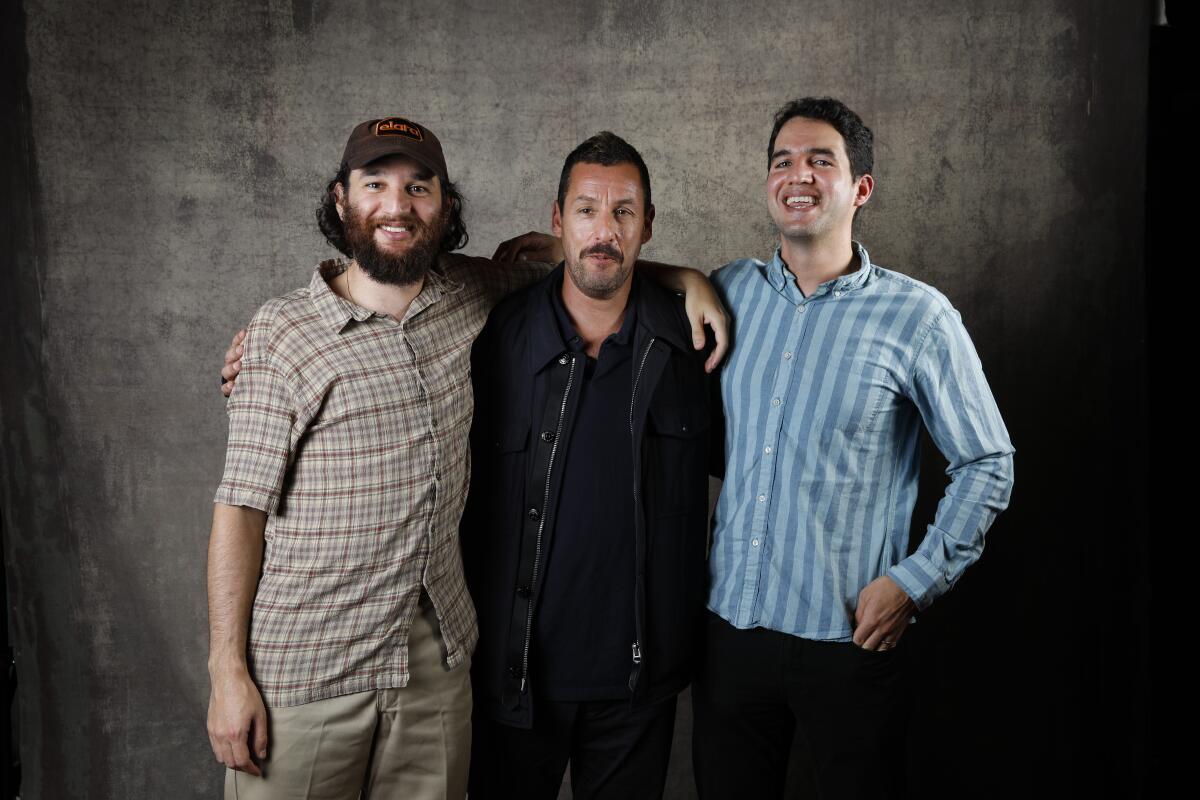 Benny Safdie, left, Adam Sandler and Josh Safdie