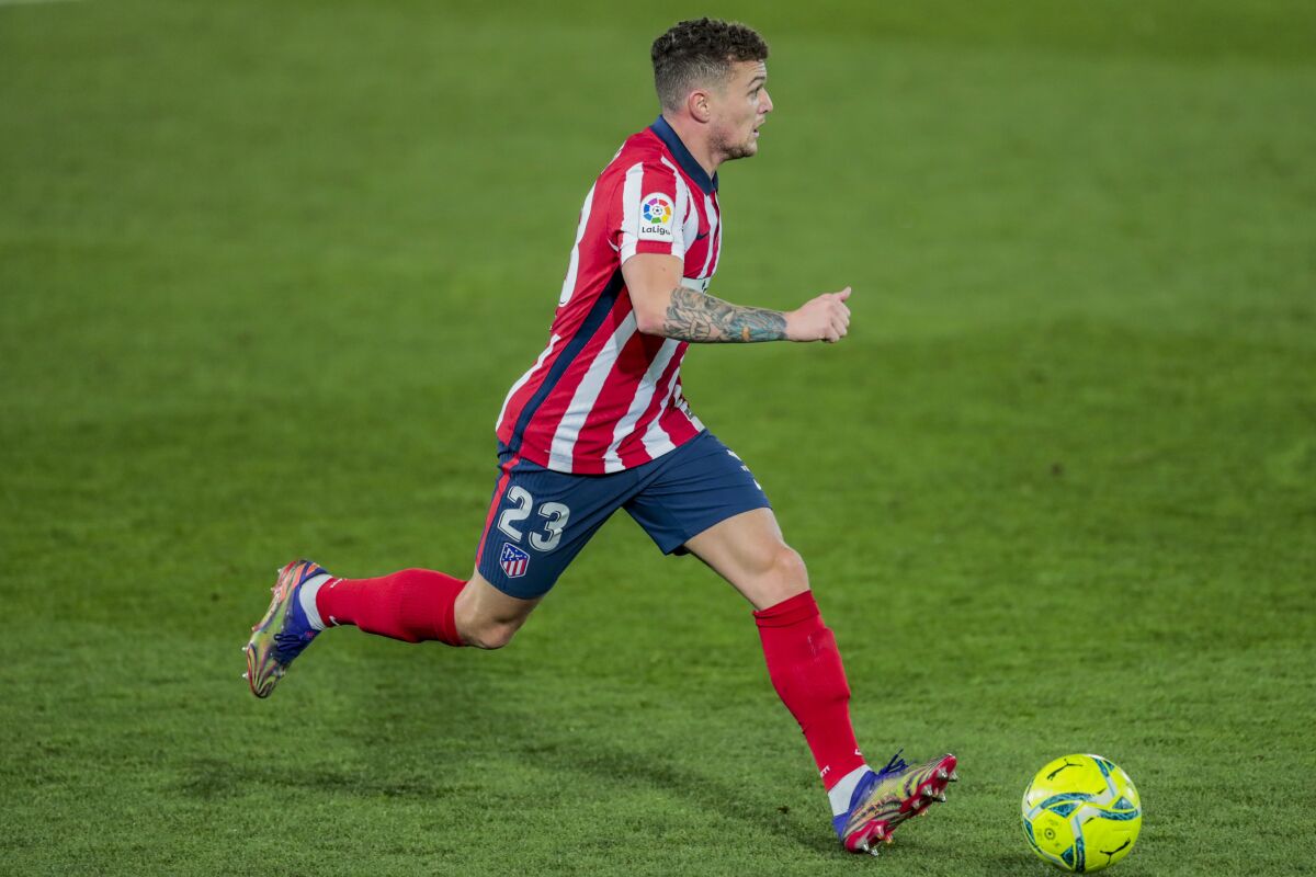 FILE - In this Saturday, Dec. 12, 2020 file photo, Atletico Madrid's Kieran Trippier runs with the ball during the Spanish La Liga soccer match between Real Madrid and Atletico Madrid at the Alfredo Di Stefano stadium in Madrid, Spain. England and Atletico Madrid defender Kieran Trippier has been banned from football for 10 weeks and fined $94,000 for breaching betting rules in a punishment from The English Football Association that applies worldwide. The misconduct denied by Trippier happened in July 2019 — the month he left Tottenham for Atletico. The FA said an independent regulatory commission proved four of the breaches but dismissed three allegations during a personal hearing. (AP Photo/Bernat Armangue, File)