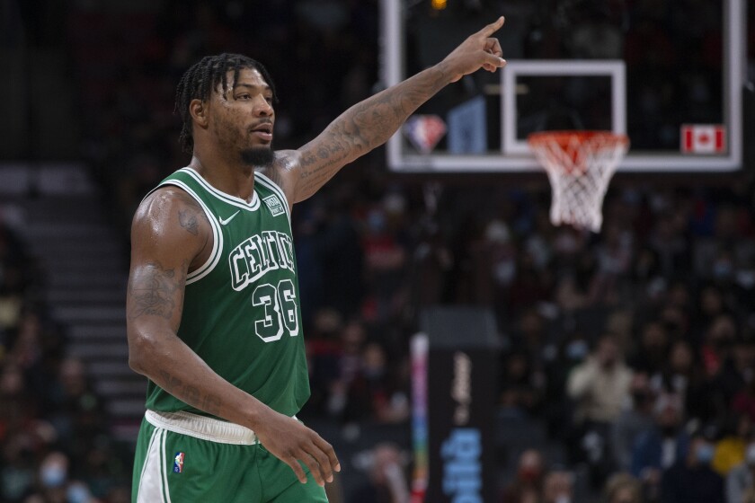 Boston Celtics Marcus Smart signals a play during the second half of an NBA basketball game against the Toronto Raptors Sunday, Nov. 28, 2021 in Toronto. (Chris Young/The Canadian Press via AP)