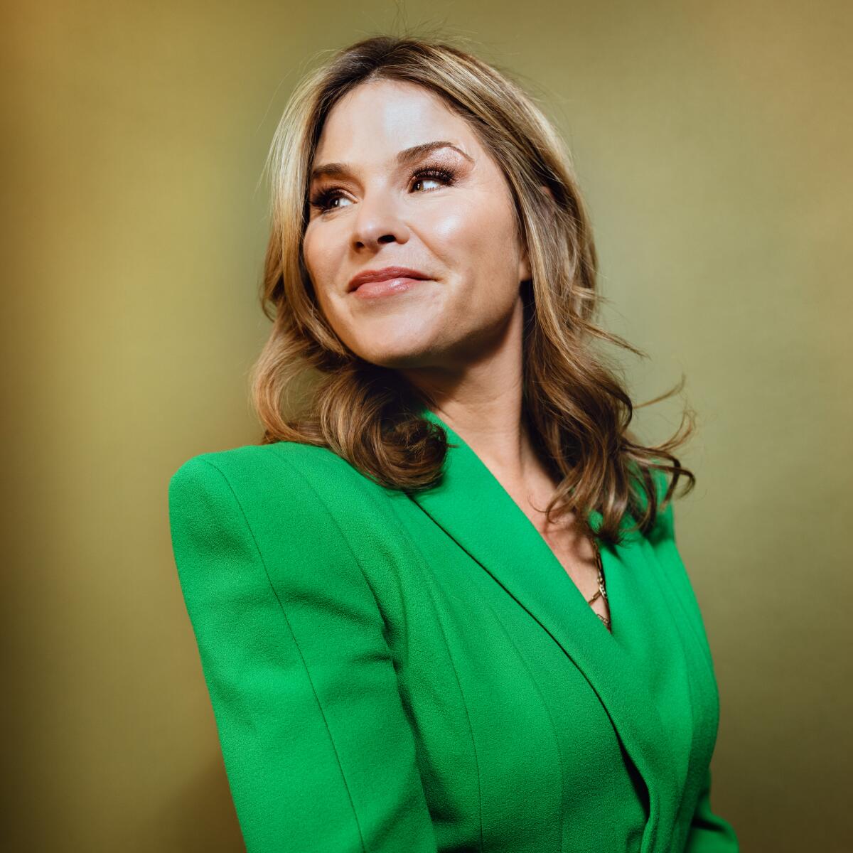 Portrait of a woman in a green business jacket