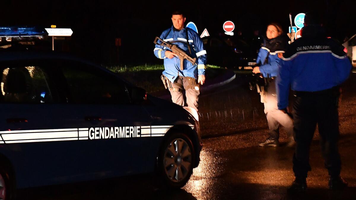 Gendarmes stand guard near a retirement home for monks in Montferrier-sur-Lez in southern France early Friday.