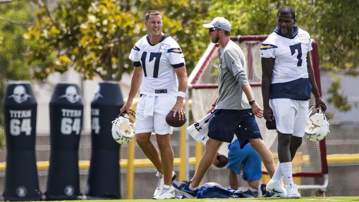 Chargers quarterbacks Phillip Rivers (17) and Cardale Jones (7) get ready to leave the field after training camp at the Jack Hammett Sports Complex in Costa Mesa on July 28.