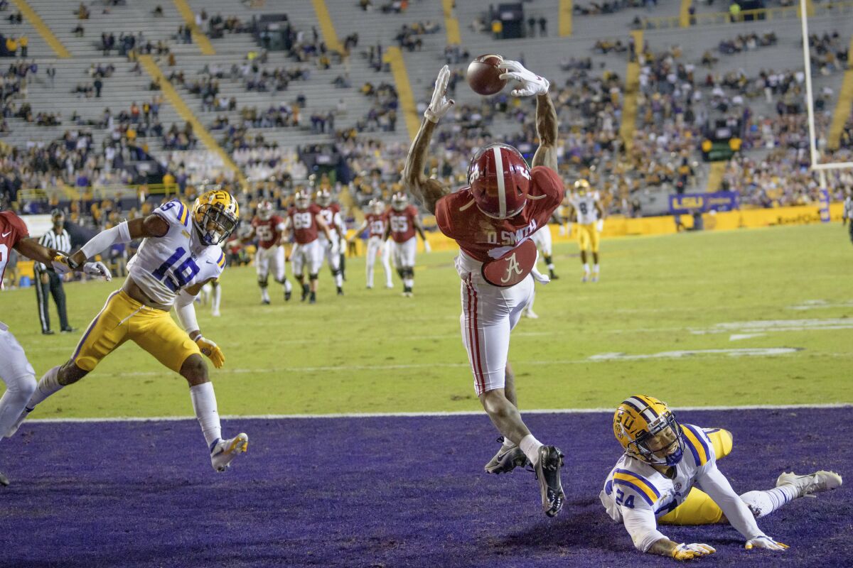 Alabama wide receiver DeVonta Smith (6) makes a touchdown grab against LSU cornerback Derek Stingley Jr. (24) during the first half of an NCAA college football game in Baton Rouge, La., Saturday, Dec. 5, 2020. (AP Photo/Matthew Hinton)