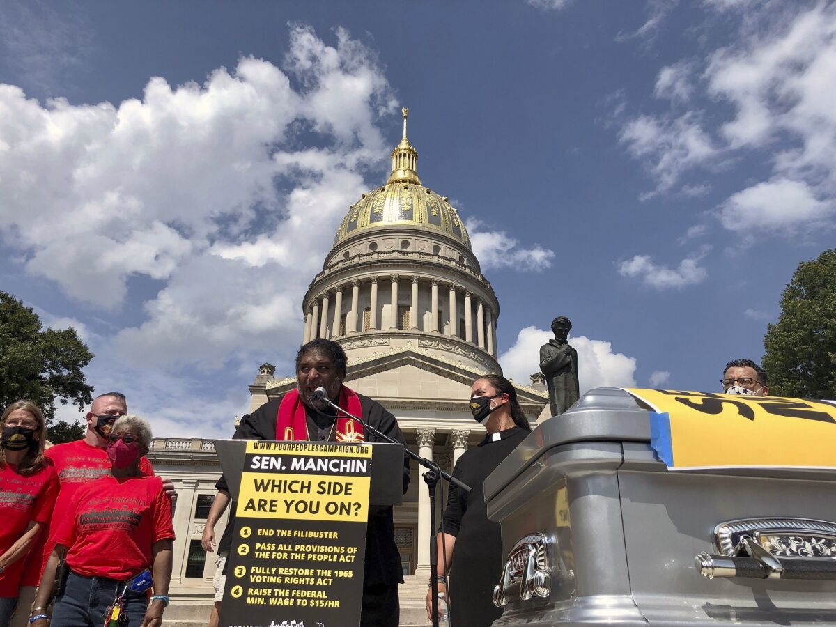 The Rev. William Barber, co-chair of the Poor People's Campaign, speaks during a rally Thursday, Aug. 26, 2021, at the state Capitol in Charleston, W.Va. The rally was aimed at applying pressure on U.S. Sen. Joe Manchin, who has opposed a sweeping overhaul of U.S. election law and a $15 federal minimum wage. (AP Photo/John Raby)