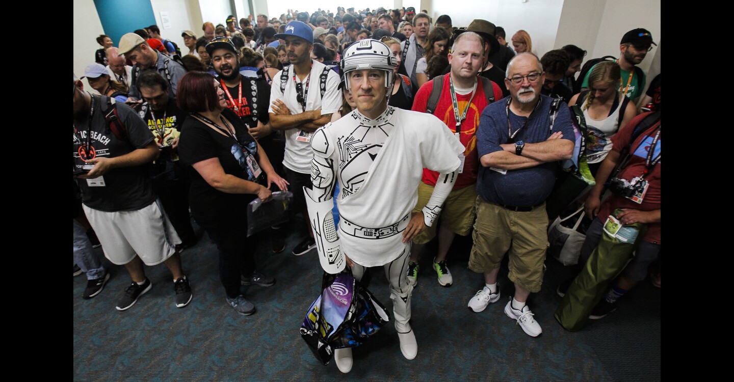 David Fleming, from Green Bank, West Virginia, who is dressed in a costume portraying Kevin Flynn in the movie Tron, stands with other convention goers as they wait in line for the start of Comic-Con International's Preview Night.