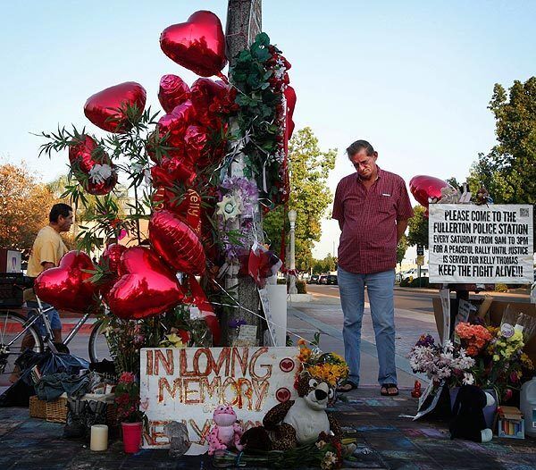 A supporter of Kelly's Army pays his respects at the site in Fullerton where Kelly Thomas was involved in an altercation with police that led to his death.