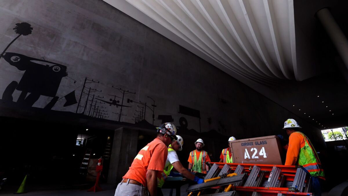 Construction workers haul equipment at the Wilshire Grand Center in downtown Los Angeles on June 1.