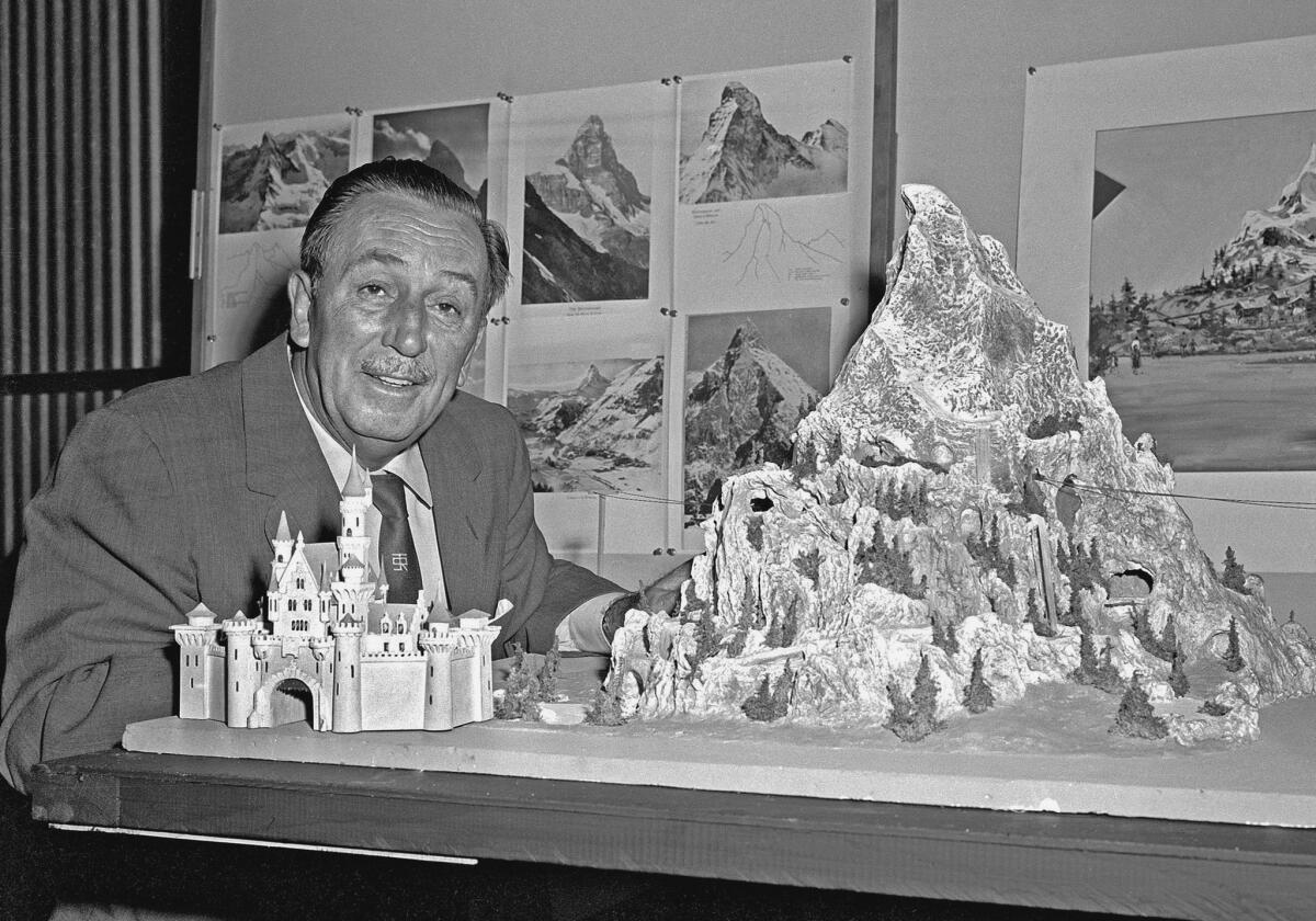 Walt Disney reviews a model for the Matterhorn Bobsleds, which opened in 1959.