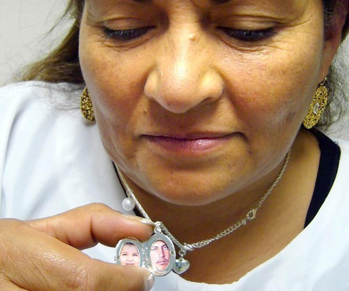 Luz Marina Bernal has a photo of her son Leonardo Porros, in her locket. Porros was lured by a false promise of work and then killed by Colombian soldiers who tagged him as a terrorist slain in combat.