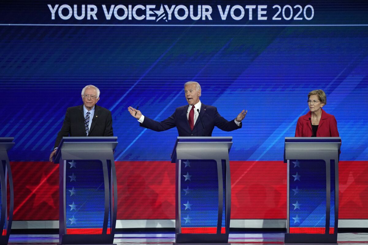 Sen. Bernie Sanders, I-Vt., left, and Sen. Elizabeth Warren, D-Mass. listen as former Vice President Joe Biden speaks during the Democratic presidential primary debate hosted by ABC at Texas Southern University in Houston on Thursday.