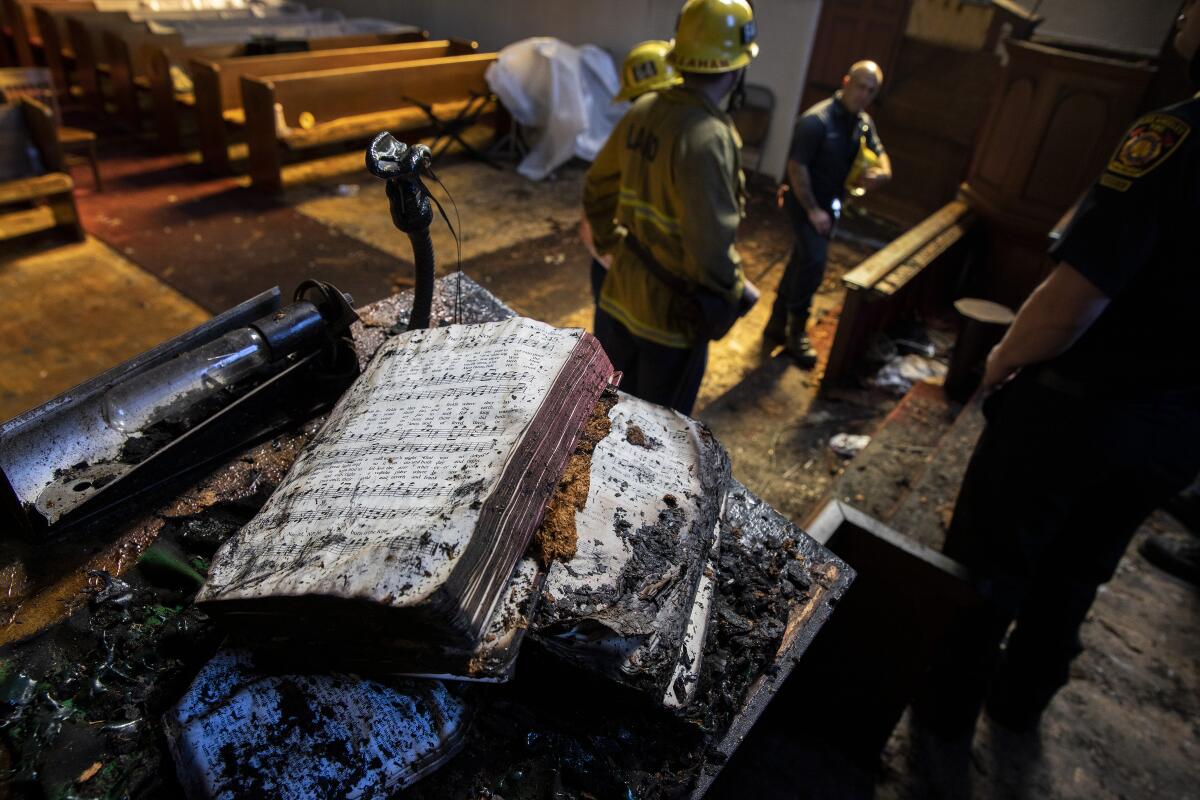 A singed hymnal on the pulpit in the aftermath of a fire at St. Johns United Methodist Church Sunday.