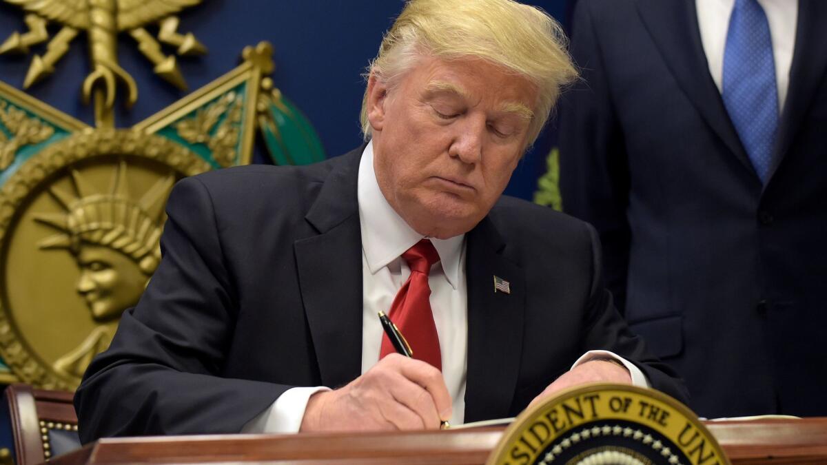 President Trump signs his executive order on immigration.