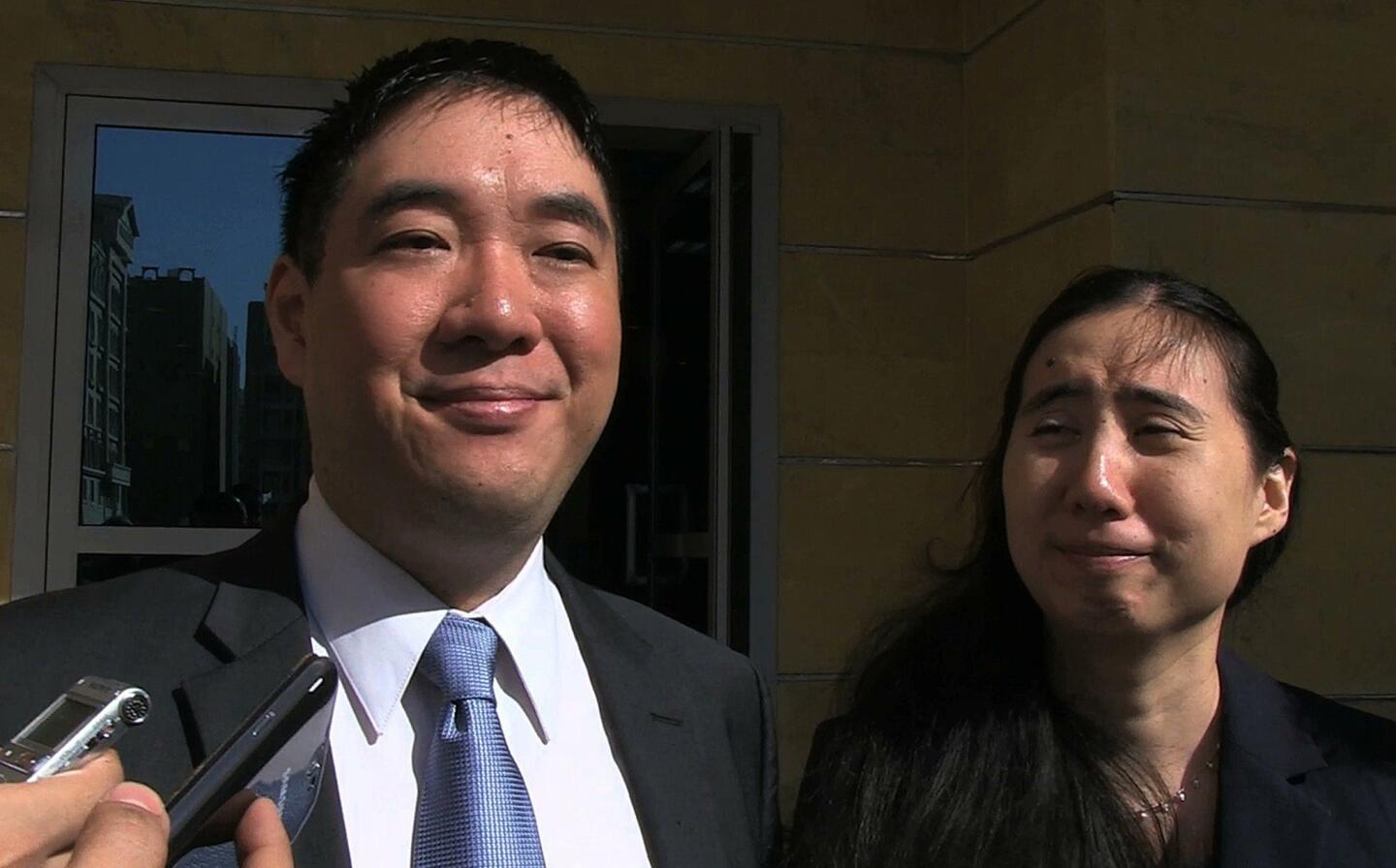 Matthew and Grace Huang talk to journalists Nov. 30 after a Qatari appeals court threw out charges against them in the death of their daughter.
