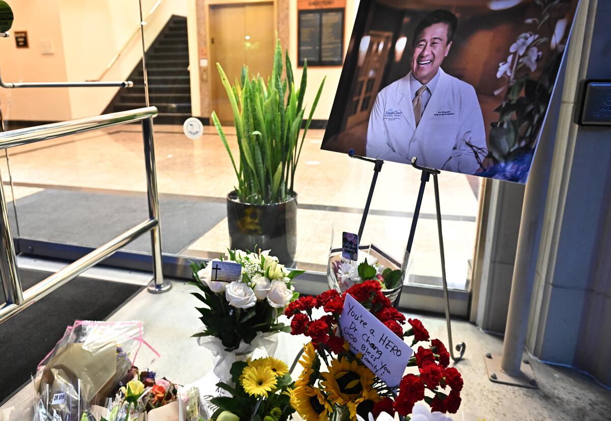 Flowers surround a photo of a doctor