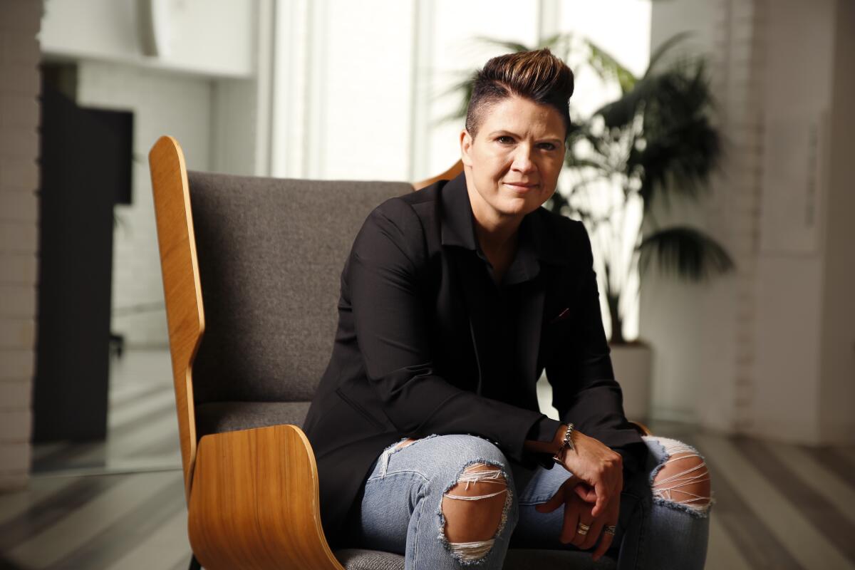 A woman leans forward while sitting in a chair