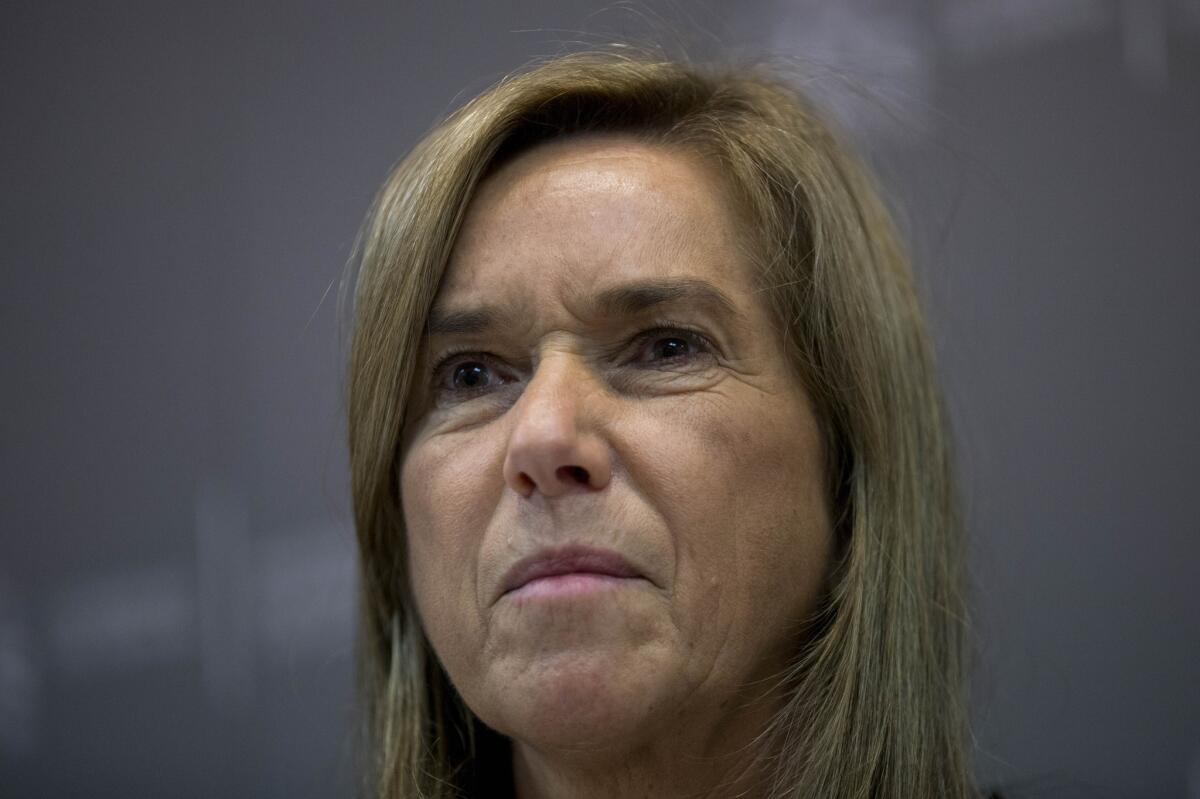 Spanish Health Minister Ana Mato listens to a question during a news conference Oct. 6 in Madrid. A Spanish nurse who treated two priests for Ebola at a hospital there has tested positive for the virus.