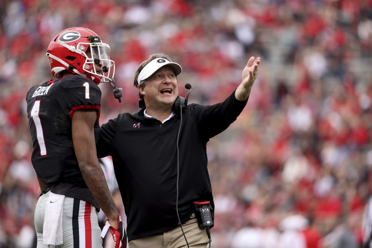 Georgia coach Kirby Smart talks with defensive back Nyland Green (1) after a play during the NCAA college football team's G-Day game Saturday, April 16, 2022, in Athens, Ga. (Jason Getz/Atlanta Journal-Constitution via AP)