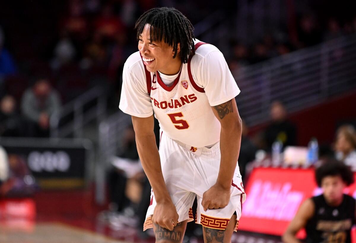 USC guard Boogie Ellis pulls at his basketball shorts as he catches his breath during a break in play.