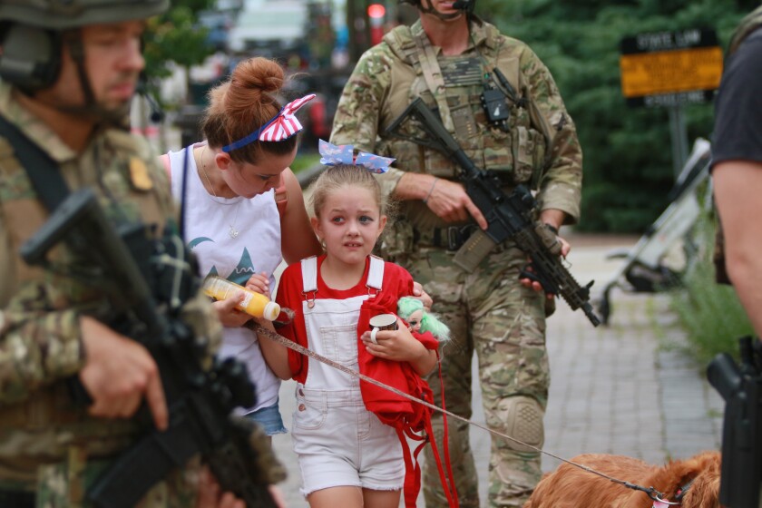 A woman and child among troops