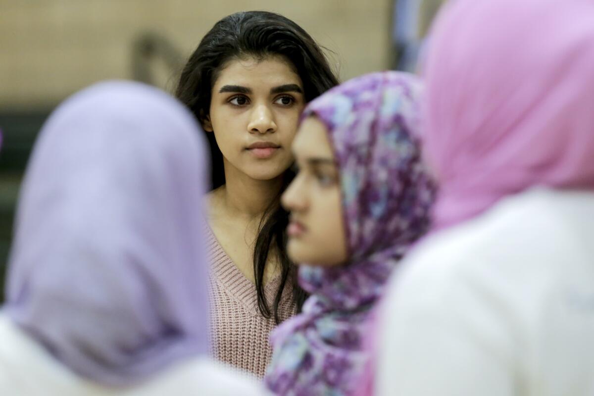 Zaina Siyed watches as her team readies for competition.