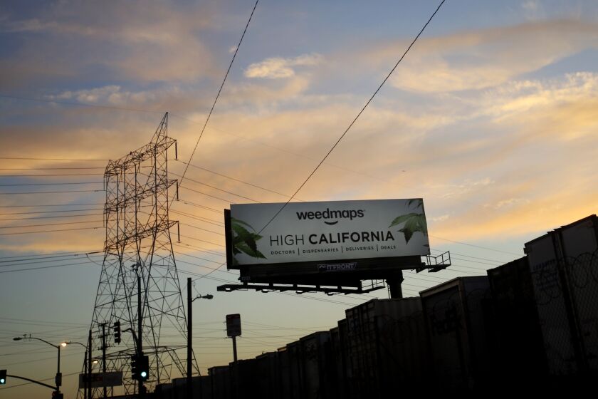A billboard advertises Weedmaps, which helps customers locate cannabis shops.