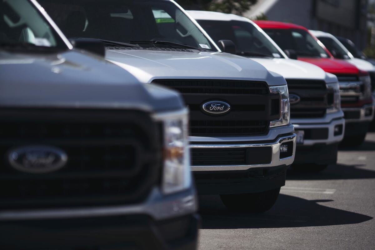 The blue Ford emblem is seen on a new trucks at a dealership in Long Beach.