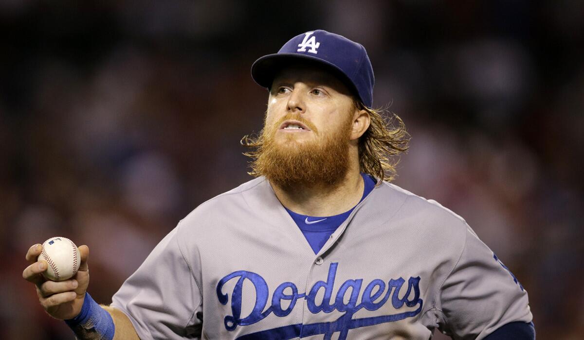 Dodgers third baseman Justin Turner walks off the field during a game against the Angels on Wednesday.