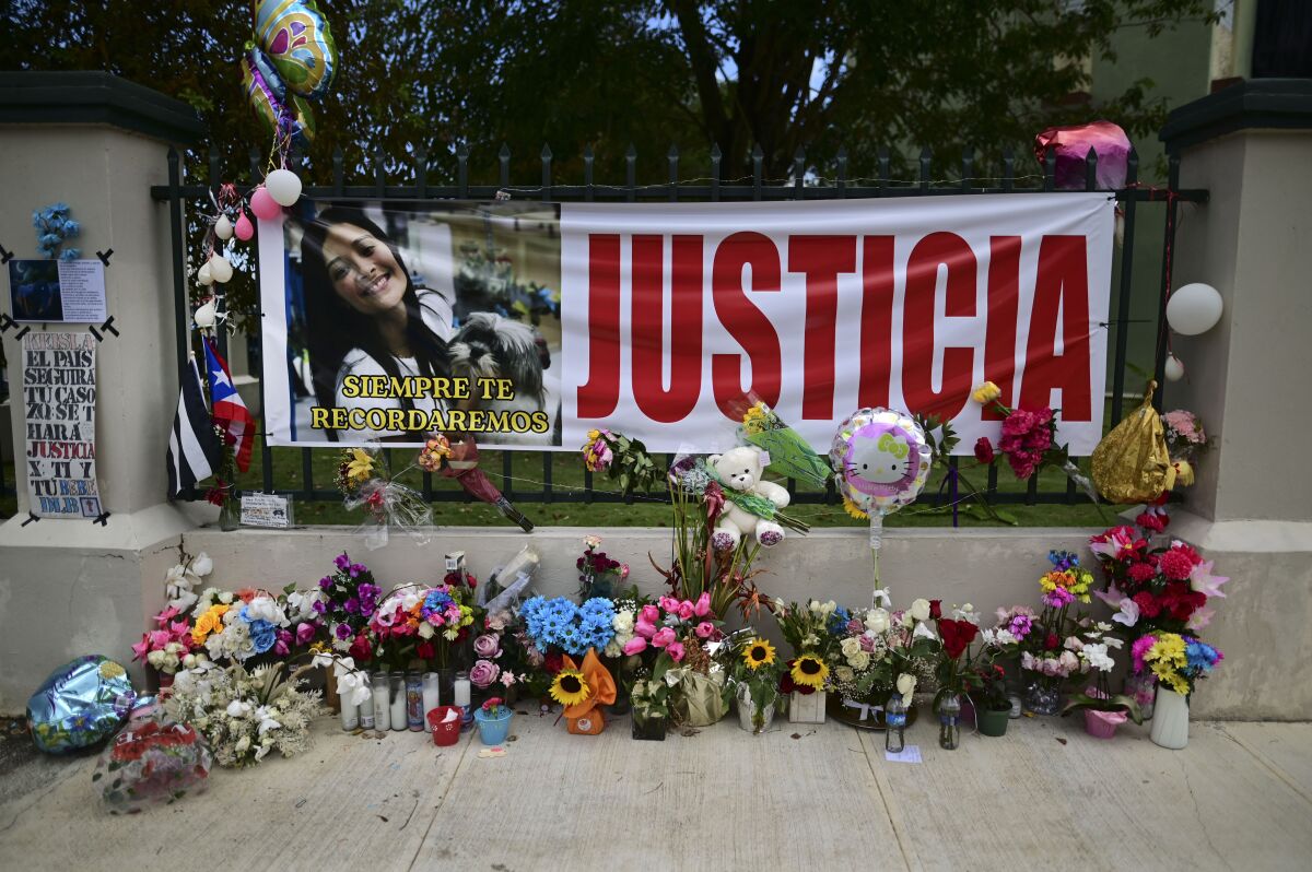 Flowers, balloons and a poster with the Spanish word for "justice" is part of a growing makeshift memorial for Keishla Rodriguez whose lifeless body was found in a lagoon Saturday, at the entrance of where she lived in San Juan, Puerto Rico, Thursday, May 6, 2021. A federal judge on Monday ordered Puerto Rican boxer Felix Verdejo held without bail after he was charged with the death of Keishla Rodriguez and with intentionally killing the unborn child she was carrying. (AP Photo/Carlos Giusti)